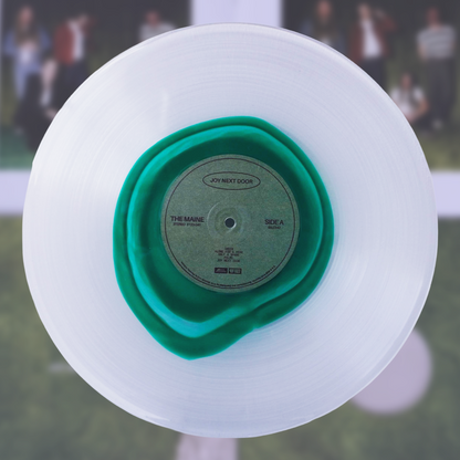 The Maine joy next door LP is a translucent white vinyl record with a vibrant glass clear green inner ring and black text label