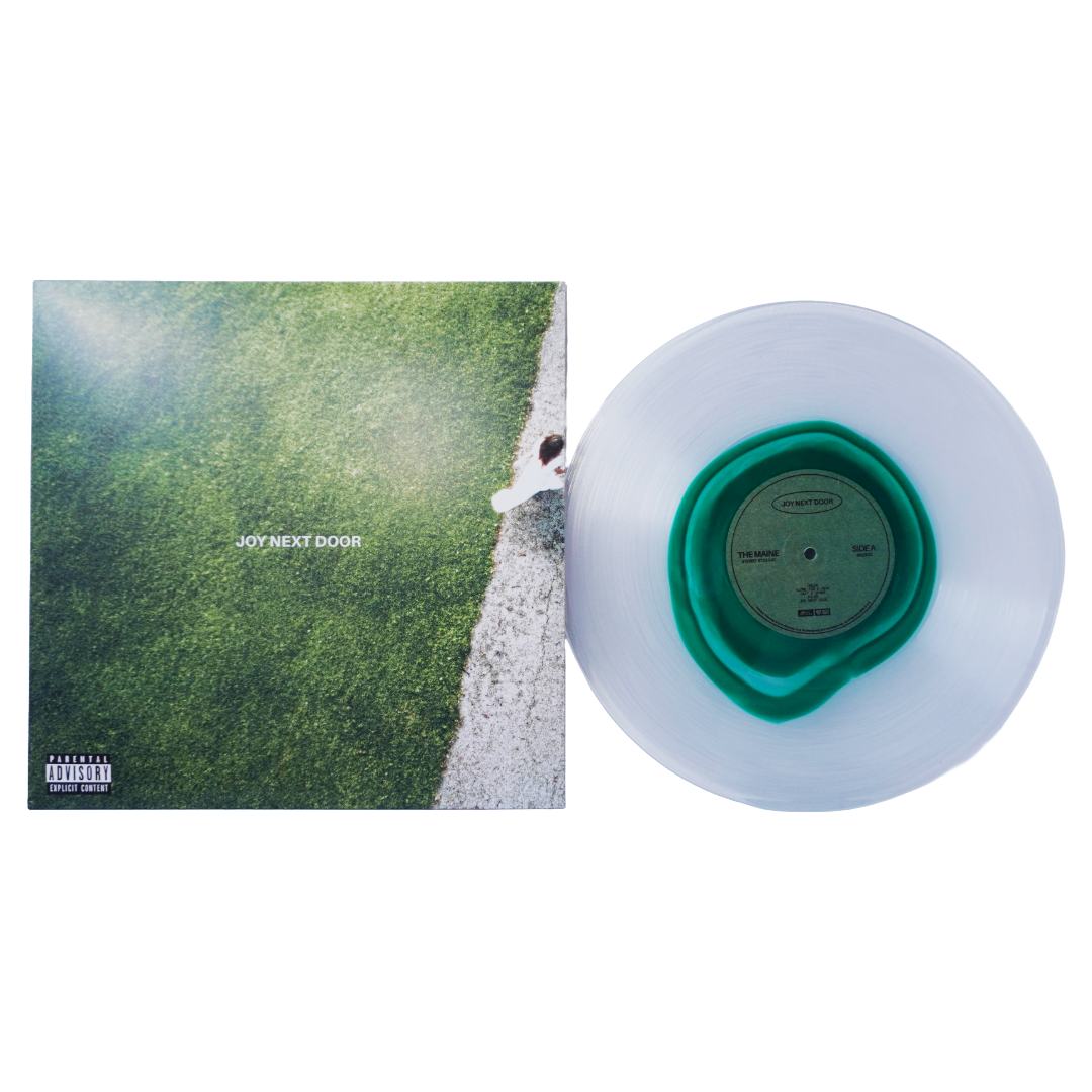Translucent white vinyl record with glass clear green center label and matching inner ring beside the maine joy next door lp album cover