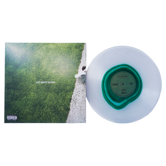 Translucent white vinyl record with glass clear green center label and matching inner ring beside the maine joy next door lp album cover
